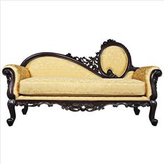 an ornately carved couch with gold upholstered fabric on the back and arms