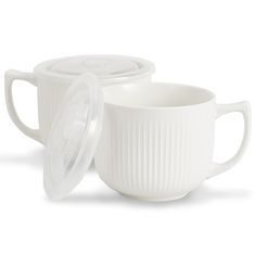 two white coffee mugs with lids on them