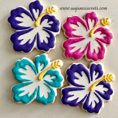 four decorated cookies with different colors and designs