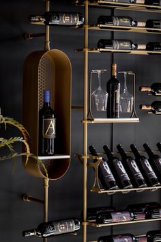 a wine rack filled with lots of bottles and glasses next to a wall mounted shelf