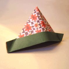 an origami paper hat sitting on top of a table