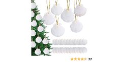 a christmas tree with white ornaments hanging from it