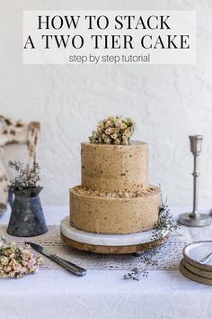 a three tiered cake sitting on top of a table next to plates and utensils