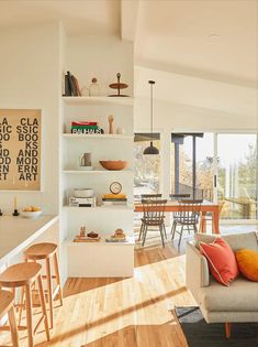 a living room filled with furniture and lots of windows