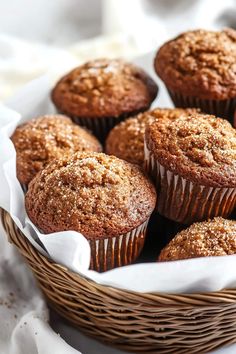 a basket filled with muffins sitting on top of a table