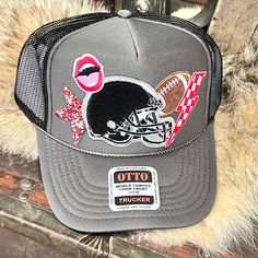 a trucker hat with an image of a football helmet and lipstick on the front