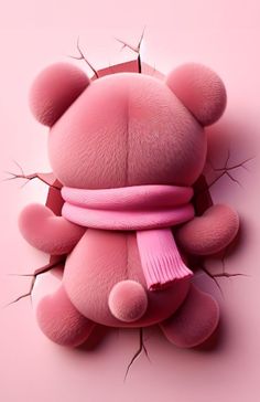 a pink teddy bear with a scarf around it's neck on a pink background