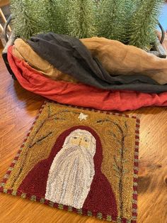 a santa clause rug sitting on top of a wooden floor next to a potted plant