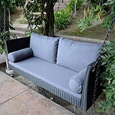 a gray couch sitting on top of a swing