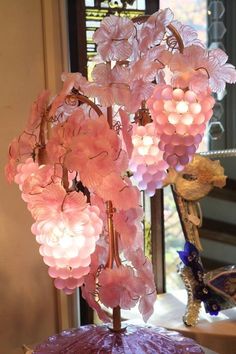 pink flowers are hanging from a chandelier