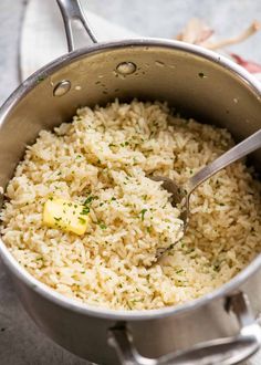 a pot full of rice with a spoon in it