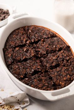 a white casserole dish filled with chocolate oatmeal