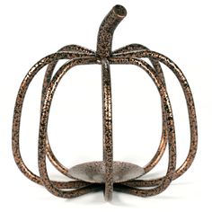 a metal pumpkin shaped object on a white background