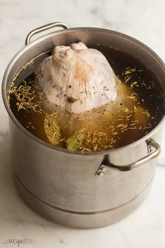 a large metal pot filled with food on top of a table