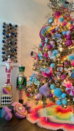 a brightly colored christmas tree with lots of ornaments