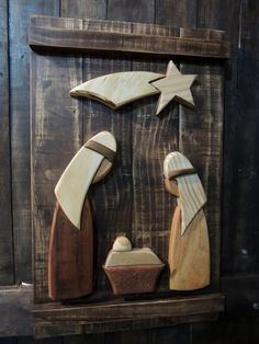 a nativity scene made out of wood with stars on the top, and a star above it