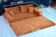 a couch that is sitting on the floor with measurements for it's size and width