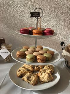 three tiered trays filled with cookies and pastries