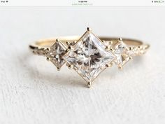 an engagement ring with three princess cut diamonds