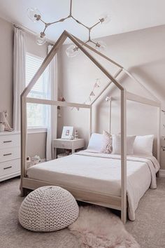 a white bedroom with a canopy bed