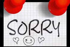 a piece of paper with the word sorry written on it and two red push buttons