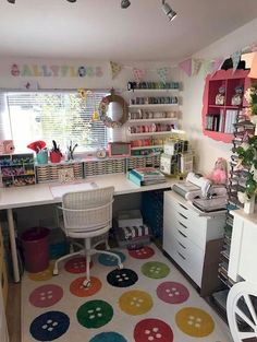 the room is decorated with colorful polka dot rugs and lots of bookshelves