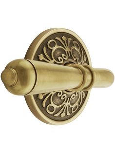 an antique brass door handle with scroll design