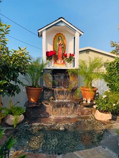 a small fountain in the middle of a garden