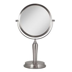 a round mirror sitting on top of a metal stand