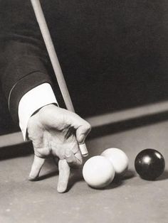 a man in a tuxedo is about to strike a pool ball with his hand