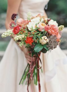 a bride holding a bouquet of flowers in her hands