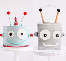 two cakes decorated to look like robots with toothbrushes in their mouths