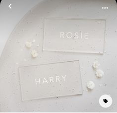 two glass coasters with the words harry and rose on them sitting on a white plate