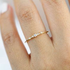 a woman's hand with a diamond ring on it