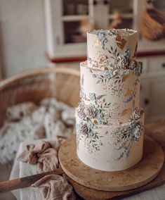 a wedding cake sitting on top of a wooden table