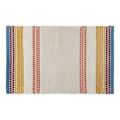 a white rug with multicolored stripes on it