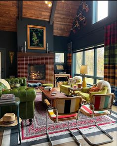 a living room filled with furniture and a fire place in the middle of a room