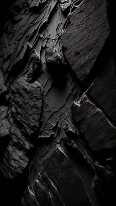 black and white photograph of rock formations with water running between them, taken from above