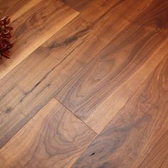 a wooden floor with a plant on top of it