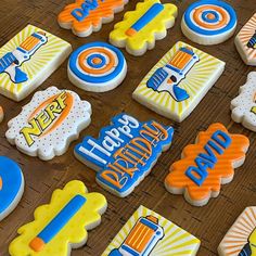 decorated cookies are arranged on a wooden table