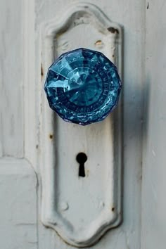 a door handle with a purple glass knob on it's side and a keyhole in the middle