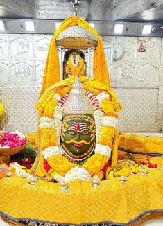 the idol is decorated with flowers and garlands