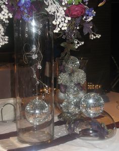 Addling bling to your wedding reception decor Purple White Wedding, White Wedding Reception, White Weddings Reception, Glass Cylinder Vases, Glass Cylinder, Cylinder Vase, Disco Balls