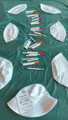 there are many crayons laid out on the table to be made into hats