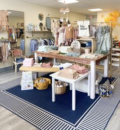 the inside of a clothing store with clothes on display