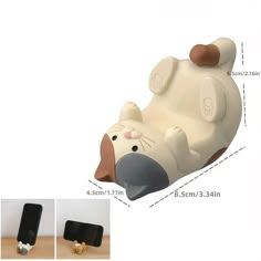 an animal shaped phone holder is shown with measurements