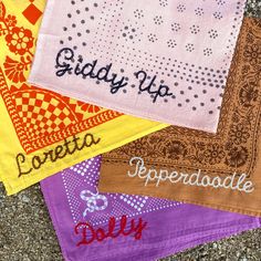 four different colored bandannas with the words giddy up, reppadded, and doly written on them