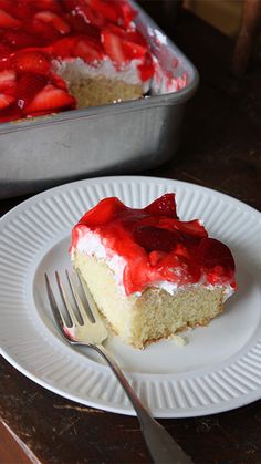 a piece of cake with strawberries on it and a fork next to the plate