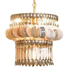 a chandelier with spoons hanging from it's sides and lots of other items