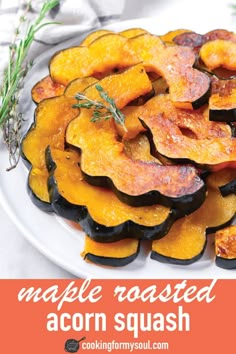 roasted acorn squash on a white plate with rosemary sprigs in the background